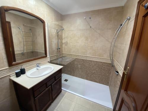 a bathroom with a sink and a shower at Stunning Villa Arabella - Heated Pool - BBQ - Amazing Terrace - Playa Blanca in Playa Blanca