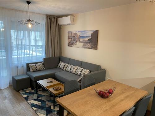 a living room with a couch and a table at Arletti Luxury Apartment in Ruse