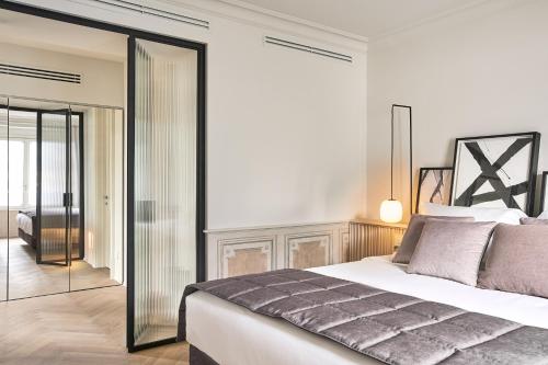 a bedroom with a bed and a glass door at Villa Làrio Lake Como in Pognana Lario