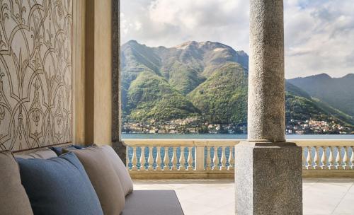 a room with a large window with a view of mountains at Villa Làrio Lake Como in Pognana Lario