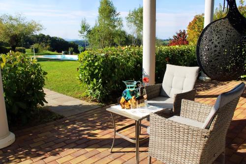 a patio with a table and chairs on a porch at Pension Lammerhof in Unterlamm
