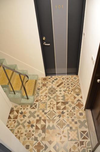 a hallway with a tile floor in front of a door at Full house in Taitung City