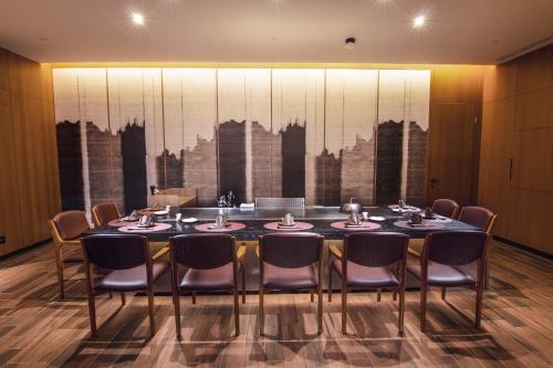 a dining room with a table and chairs at Crowne Plaza Tainan by IHG in Tainan