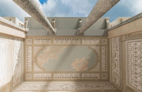 a large screen television in a room with a ceiling at Villa Làrio Lake Como in Pognana Lario