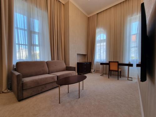 a living room with a couch and a table at Tiffi Old Town Hotel in Warsaw