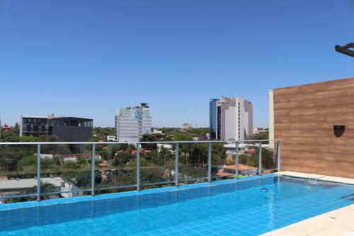 a swimming pool on the roof of a building at START Villa Morra Rent Apartments in Asuncion