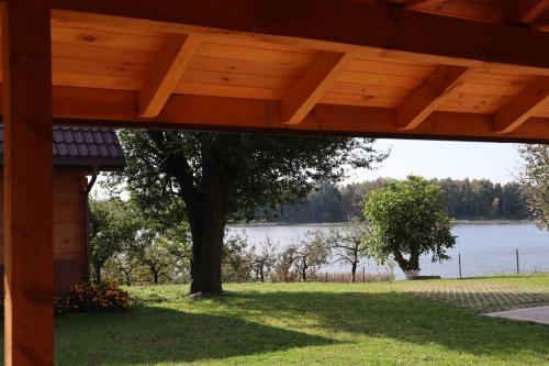 a view of a lake from the porch of a house at FraToLe in Nielisz