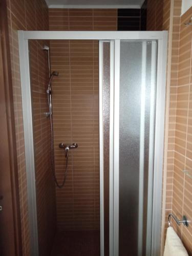 a shower in a bathroom with a glass door at Borostyán Vendégház Eger in Eger