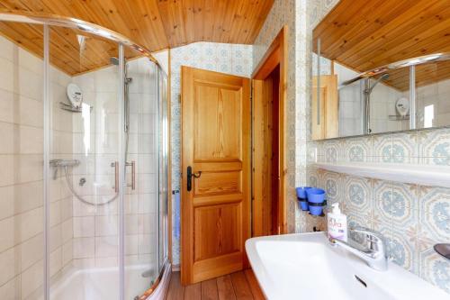 a bathroom with a shower and a tub and a sink at Chalet ChouChou in Morgins