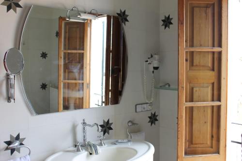 a bathroom with a mirror and a sink at Sant Jaume in Alcudia