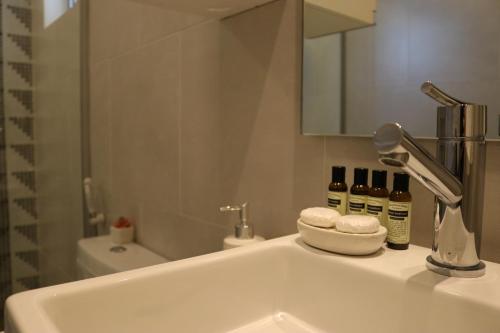 a bathroom with a sink with a mirror and a sink at START Villa Morra Rent Apartments in Asuncion