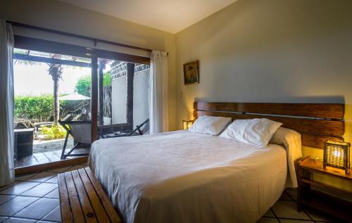 a bedroom with a large bed and a large window at Las Olas in Máncora