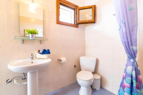 a bathroom with a toilet and a sink at F & B Summer Collection - Kassandra - Fourka in Skála Foúrkas
