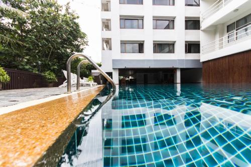 a swimming pool in front of a building at Chiang Mai Hill Hotel in Chiang Mai