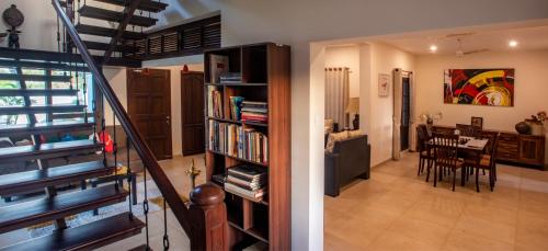 a staircase leading to a living room and a dining room at The Ambassador's Residence Kochi - a VKation Experience in Cochin