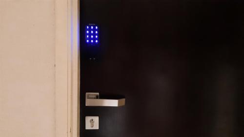 a blue light on the side of a black refrigerator at Cuti de Gold Coast Morib in Banting