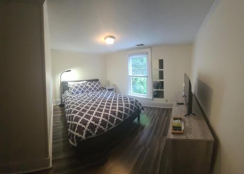 a bedroom with a bed and a window at The Dragon's Den 5 bedroom house 1 mile to Main St in Tazewell