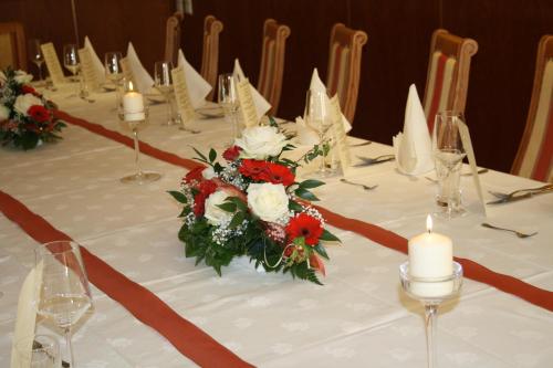 a long table with candles and flowers on it at Posthotel Radstadt in Radstadt