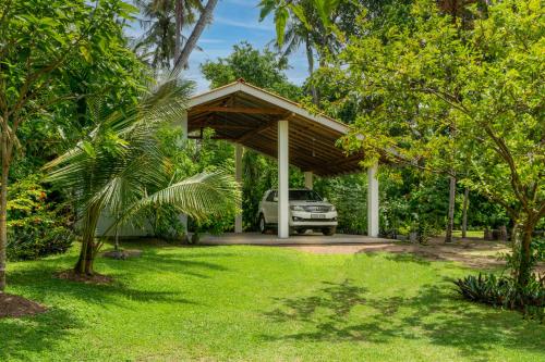 a car parked under a pavilion in a yard at 5BR Luxury Villa with Pool the Blues in Mihiripenne