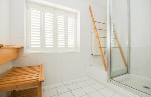 a bathroom with a shower and a window at Kemp Town House - Parking - by Brighton Holiday Lets in Brighton & Hove