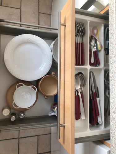 a cupboard filled with plates and utensils at Constantin in Bochum