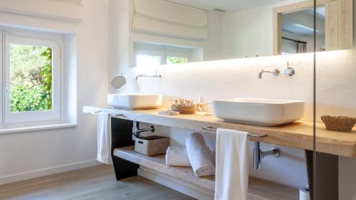 a bathroom with two sinks and a mirror at Hotel Mas Pastora - Adults Only in Llafranc