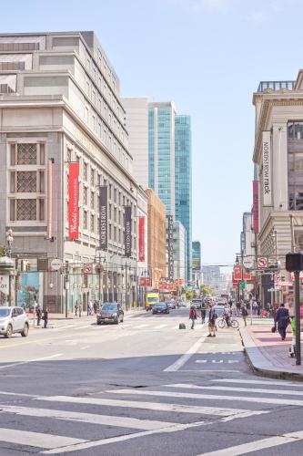 a busy city street with cars and people crossing the street at FOUND Hotel, San Francisco in San Francisco