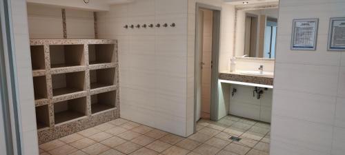 a bathroom with a sink and a mirror at Trafalgar Apartment 133 in Cuxhaven