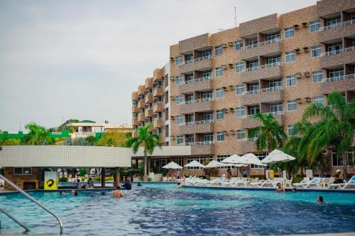 a swimming pool in front of a large building at Gran Lençois Resort in Barreirinhas