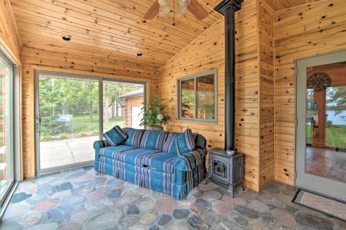 a living room with a couch and a stove at Spacious Lakefront Home with Patio and Boat Dock! in Laporte