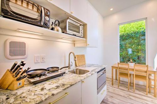 a kitchen with a sink and a counter top at Convenient Salt Lake Tiny Home with Chic Interior! in South Salt Lake