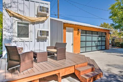 a wooden deck with chairs and a table at Convenient Salt Lake Tiny Home with Chic Interior! in South Salt Lake