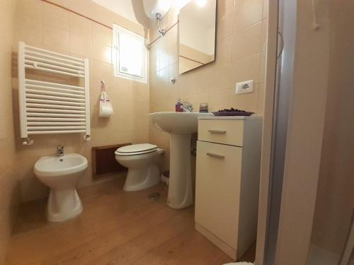 a small bathroom with a toilet and a sink at Alloggio Turistico Sutri in Sutri