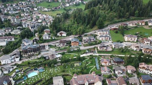 an aerial view of a town with buildings and trees at Villa Hubertus in Ortisei