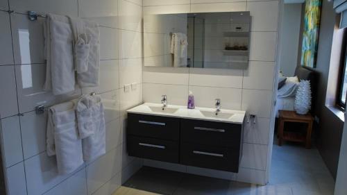 a bathroom with a sink and a mirror at Diamante 181 Luxury home in Gold Coast 4 Bedrooms 3 Bath in Palm-Eagle Beach