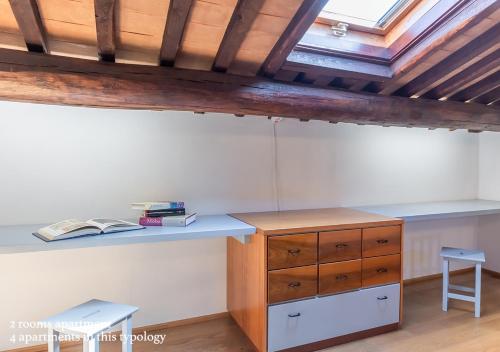 a room with a desk and a table and chairs at Borgo Solario in Castiglione del Lago