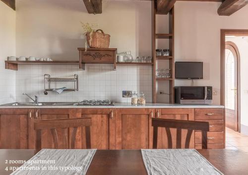 a kitchen with a sink and a stove top oven at Borgo Solario in Castiglione del Lago
