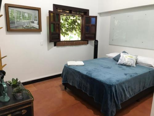 a bedroom with a bed and a window at Finca Hotel Brasilia in La Tebaida