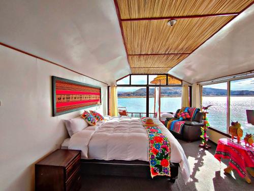 ein Schlafzimmer mit einem großen Bett in einem Zimmer mit Fenstern in der Unterkunft Uros Qhantany Lodge in Puno
