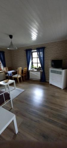 an empty living room with a table and a television at FeWo Am Marktplatz in Zerf