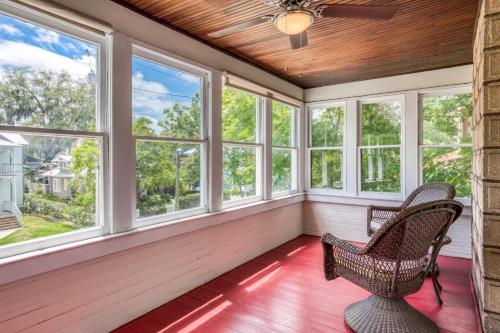 a screened in porch with two chairs and windows at 16 Saragossa Street B in St. Augustine