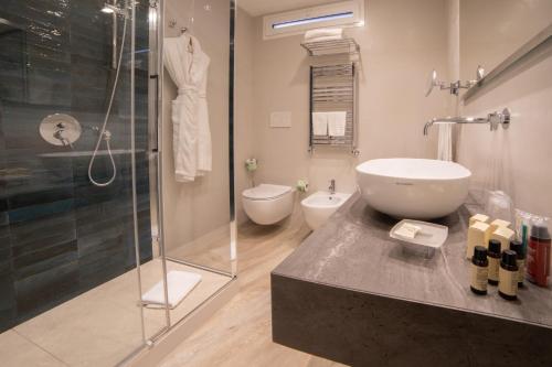 a bathroom with a shower and a sink and a toilet at Splendid Hotel Taormina in Taormina