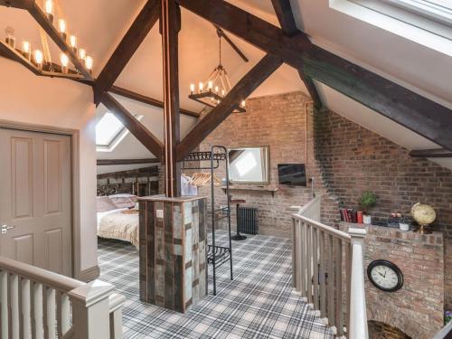 a attic bedroom with a bed and a staircase at Newgate Loft in Morpeth