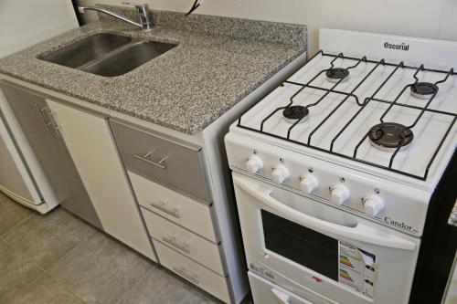 a kitchen with a stove and a sink at CHIVILCOY APART in Chivilcoy