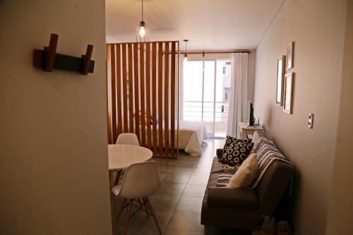 a living room with a couch and a table and a bed at CHIVILCOY APART in Chivilcoy