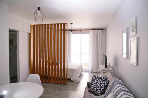 a room with a bedroom with a bed and a window at CHIVILCOY APART in Chivilcoy