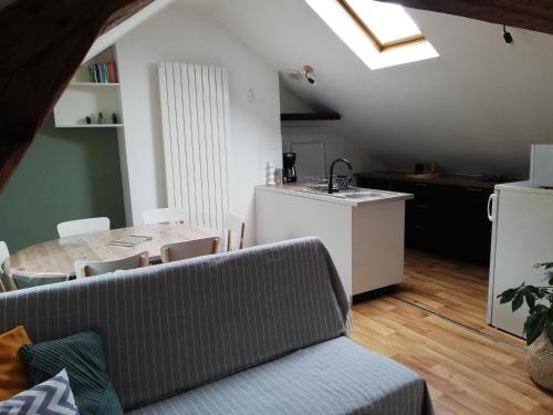 a living room with a couch and a table at La Plage in Fécamp