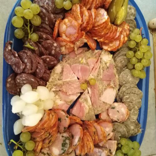 a blue plate of food with shrimp and grapes at Vinný sklep Kovárna - Nad Presovnou in Rohatec