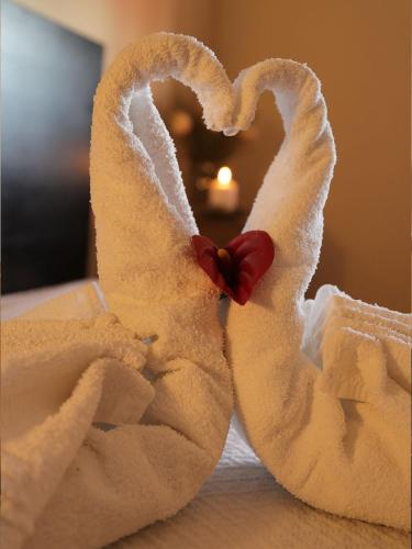 a towel shaped like a swan sitting on a bed at SEIA Apartamentos Serra da Estrela in Seia