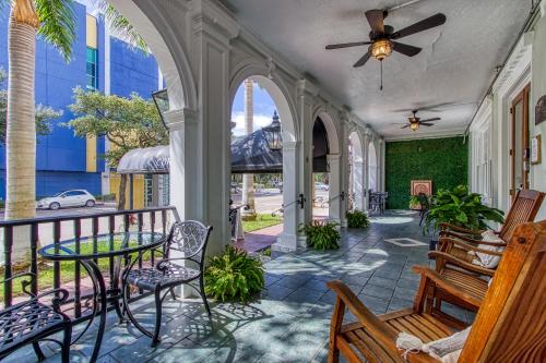 a porch with chairs and a table and a ceiling fan at New Hotel Collection Downtown St Pete in St Petersburg